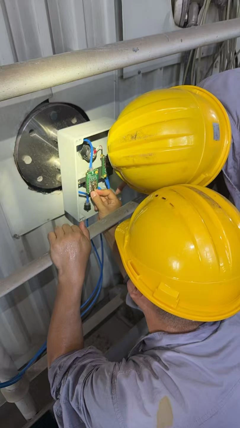 Customer photograph of engineers installing an instrument at a duct